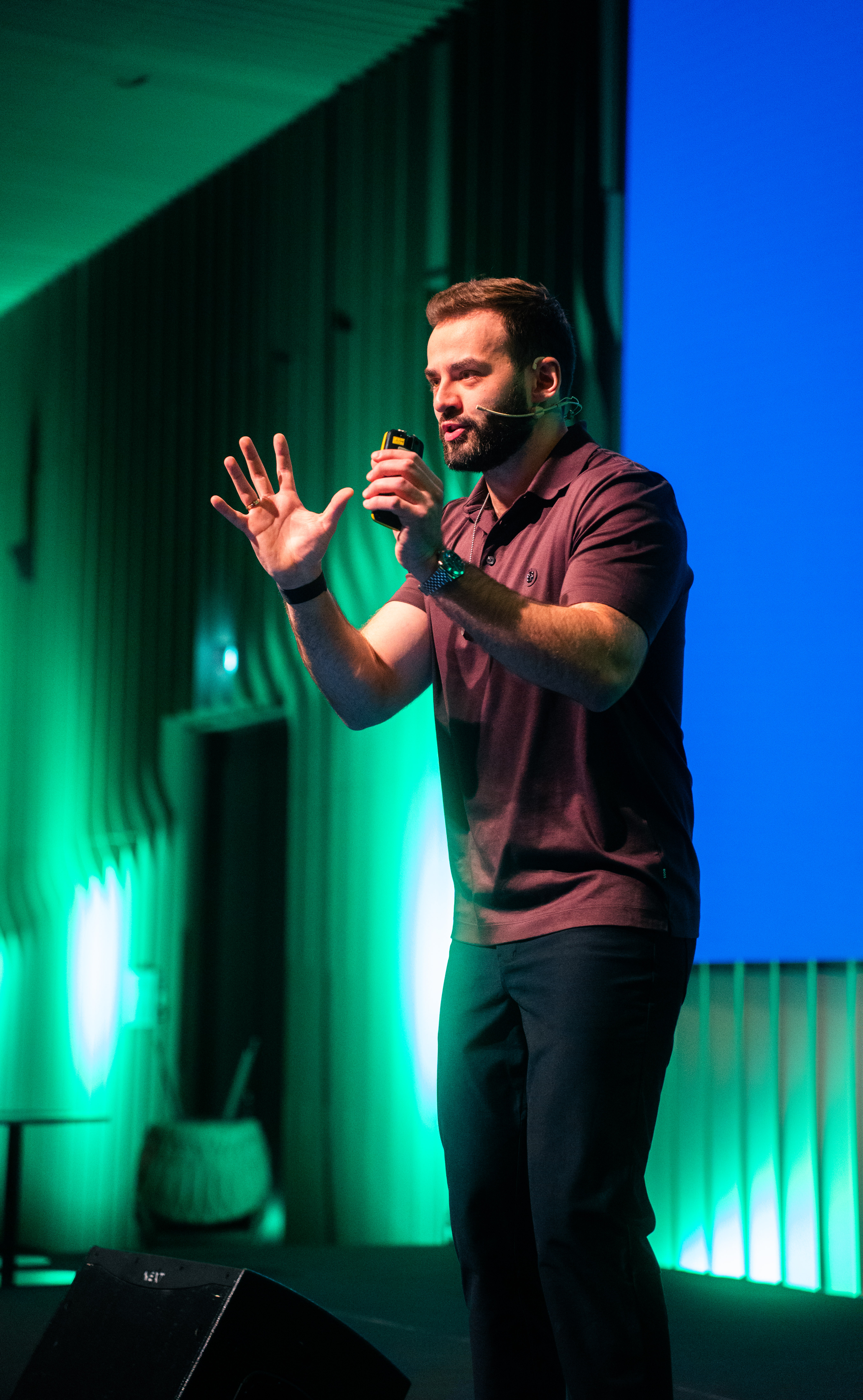 Niks Jansons speaking on stage